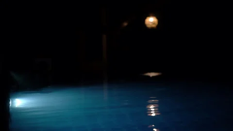 Tranquil Swimming Pool at Night with Blue Light and Glowing Lantern Reflection Stock Footage 340068296