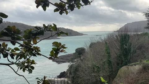 A tranquil tripod video capturing the sun peeking through clouds over Salcombe Stock Footage 301763067