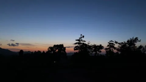 Tranquil Tropical Sunset Sky with Silhouetted Trees and Mountains Stock Footage 313196461