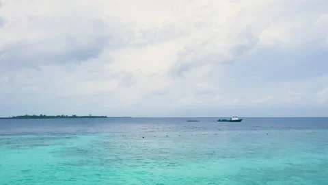 Tranquil Turquoise Waters of the Maldives with Distant Boat: A Scene of Peace an Stock Footage 287700011