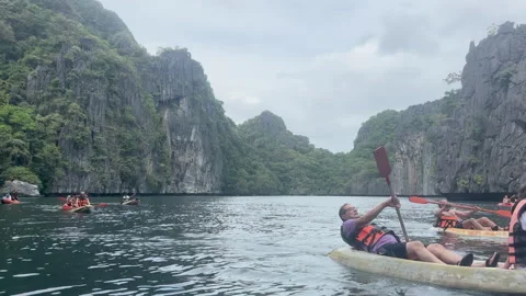 Tranquil turquoise waters reflect the surrounding cliffs and lush greenery Stock Footage 313283001