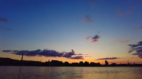 Tranquil Twilight: Sun Setting over City and River Video stock 249670370