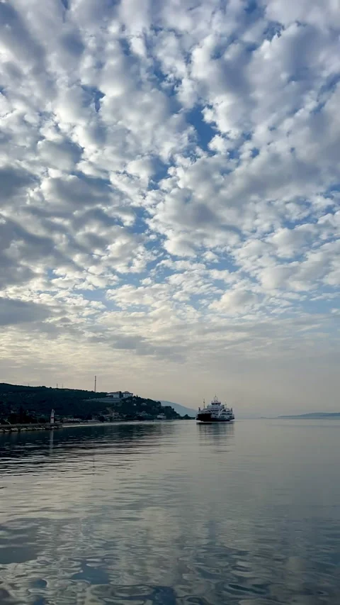 A tranquil view of calm waters reflecting fluffy clouds above Stock-Footage 316161852