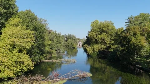 A tranquil view of the Canal du Loing in Moret-sur-Loing, France, captured on a Stock Footage 346718594