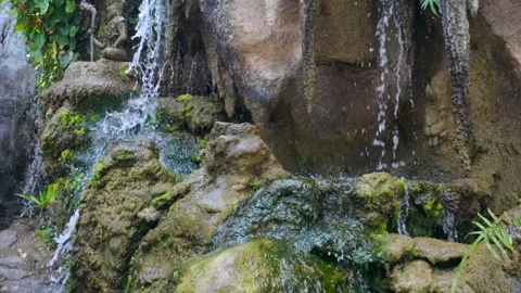 A tranquil view of the serene waterfall cascading over moss-covered rocks Stock Footage 309330740