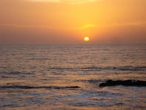 Tranquil view of the sunset over the ocean Stock Photos
