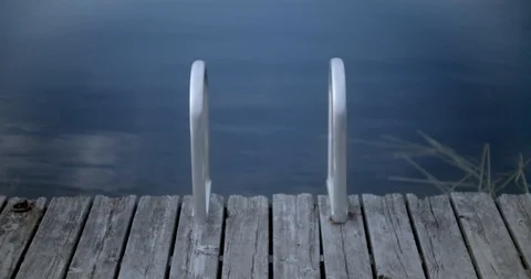 Tranquil water in a small bay overlooking trees and sky Stock Footage 120699980