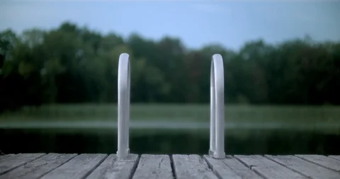 Tranquil water in a small bay overlooking trees and sky Stock Footage 120700008