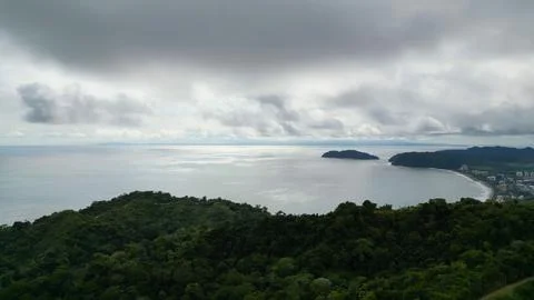 A tranquil water view, surrounded by lush trees on a cloudy day Stock Photos