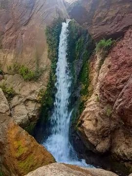 Tranquil waterfall cascading between the rocks is the essence of flowing water Stock Photos