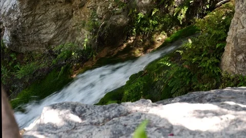 Tranquil waterfall cascading over moss-covered rocks . Close-up Stock Footage 305031600