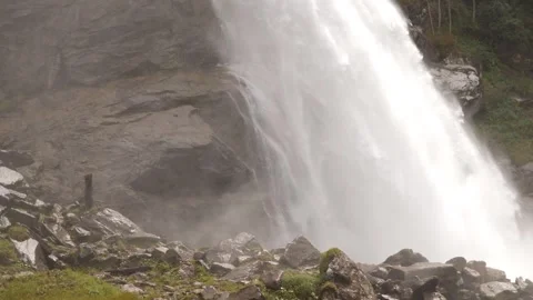 A tranquil waterfall is gracefully flowing over rocky terrain in a beautiful Stock Footage 292804993