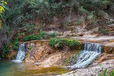 Tranquil Waterfalls Flow Into a Calm Pool, Surrounded by Lush Greenery in a.. Stock Photos