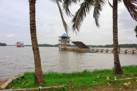A tranquil waterfront scene featuring a three-story structure and a floating  Stock Photos