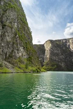 Tranquil waters and dramatic cliffs of the Naeroyfjord Stock Photos