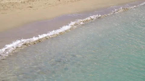 Tranquil waves gently caressing the sandy shore on a serene beach in 4k slo.. Stock Footage 268414633