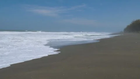 Tranquil Waves Gently Crashing on Sandy Shore at Goa Cemara Beach Stock Footage 302525071