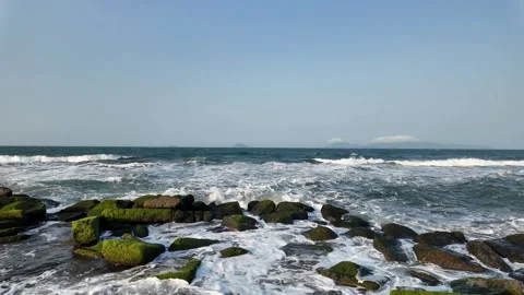 Tranquil Waves on Mossy Rocks Stock Footage 290080900