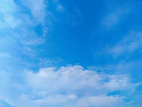 Tranquil White Cumulus Clouds in Pristine Azure Blue Summer Sky Stock Photos