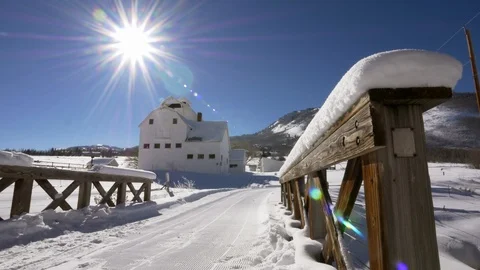 Tranquil winter scene of historic white barn with wooden bridge, Park City, UT. Video stock 99993372