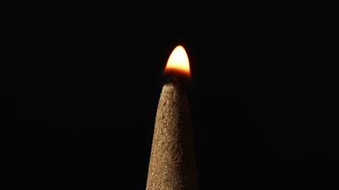 In the tranquility of a close-up, time stretches as a flame tenderly kisses the Stock Footage 257450110
