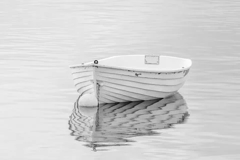 Tranquility- dingy reflected on a glassy sea Stock Photos