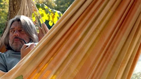 Tranquility in a hammock: relaxing in nature Stock Footage 300875045