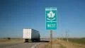 Trans Canada Highway 1 sign in Alberta, Canada. Truck passes. HD Footage