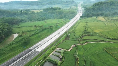 Trans-Java highway slash into extensive paddy rice cultivation area Stock Footage 277104858
