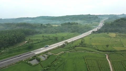 Trans-Java highway slash into extensive paddy rice cultivation area Stock Footage 277104865
