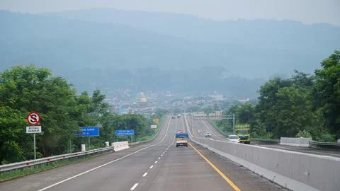 Trans Java toll road during the day, downhill road, faint background of hills Stock Photos