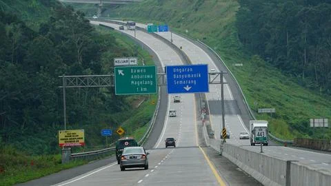 Trans Java toll road KM 443 at noon. There are signs for directions to the .. Stock Photos
