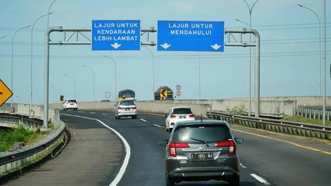 Trans Java toll road at noon with information signs Fotos de archivo