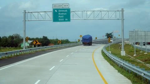 Trans Java toll road at noon. There are signs for the city of Demak, Kudus,.. Stock Photos