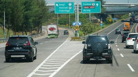 Trans Java toll road at noon. There are signs for the city of bangil, Probo.. Stock Photos