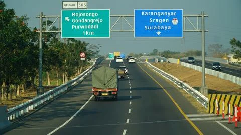 Trans Java toll road at noon. There are signs for the city of Purwodadi, Sr.. Stock Photos