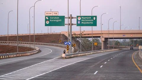 Trans Java toll road at noon. There are signs for the city of Caruban, Ngan.. Stock Photos