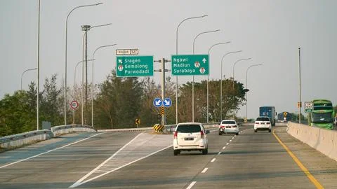 Trans Java toll road at noon. There are signs for the city of Purwodadi, Sr.. Stock Photos