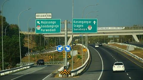 Trans Java toll road at noon. There are signs for the city of Purwodadi, Sr.. Stock Photos