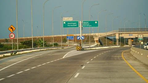 Trans Java toll road at noon. There are signs for the city of Mantingan, Pu.. Stock Photos