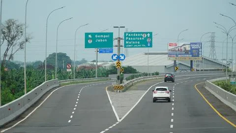 Trans Java toll road at noon. There are signs for the city of Gempol, Pasur.. Stock Photos