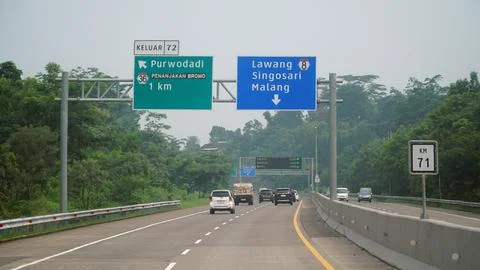 Trans Java toll road at noon. There are signs for the city of singosari, la.. Stock Photos
