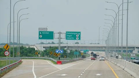 Trans Java toll road. There are signs for the city of Kendal, Jakarta, Peka.. Stock Photos