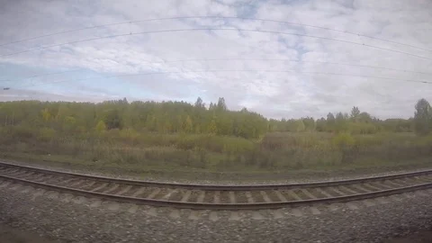 Trans-Siberian Railway Train Rolling Along Vast Open Fields in Russia Stock Footage 81539310