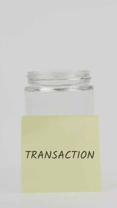 Transaction text or word on yellow sticky note attached to glass jar Stock Footage 311797487
