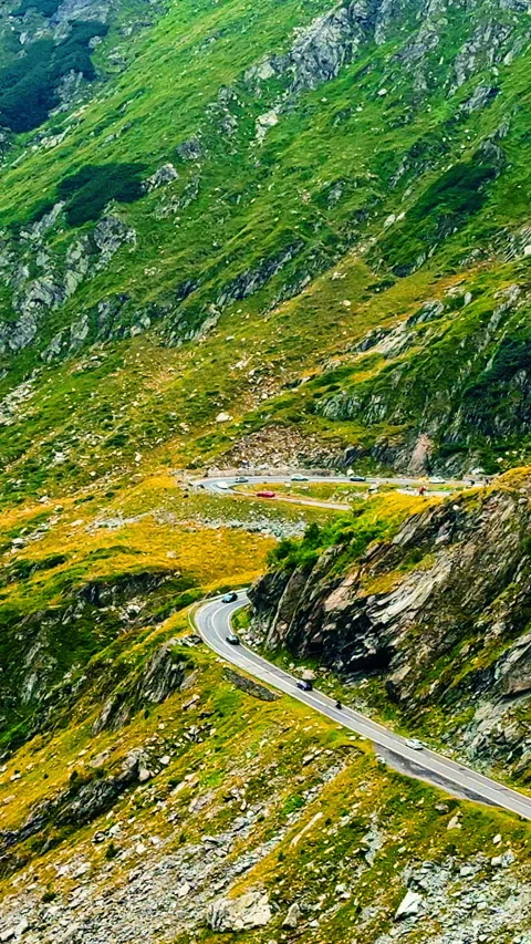 Transfagarasan mountain highway winding through steep rocky terrain. Vertical Stock Footage 333147677