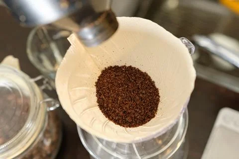 Transfer the coffee grounds to the dripper Stock Photos