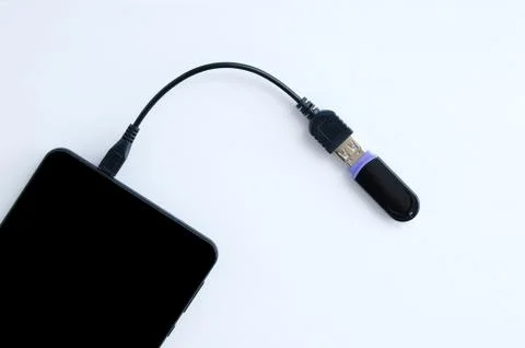 Transfer digital data. The cable is connected to the smartphone and USB flash Stock Photos