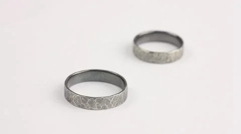 Transfer focus from one silver ring (rough texture) to another, short distance Video stock 57197389