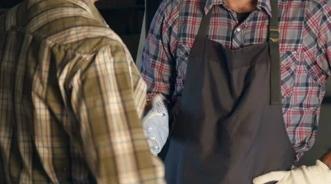 Transfer money one worker to another in workshop.Hands Видео 66344196